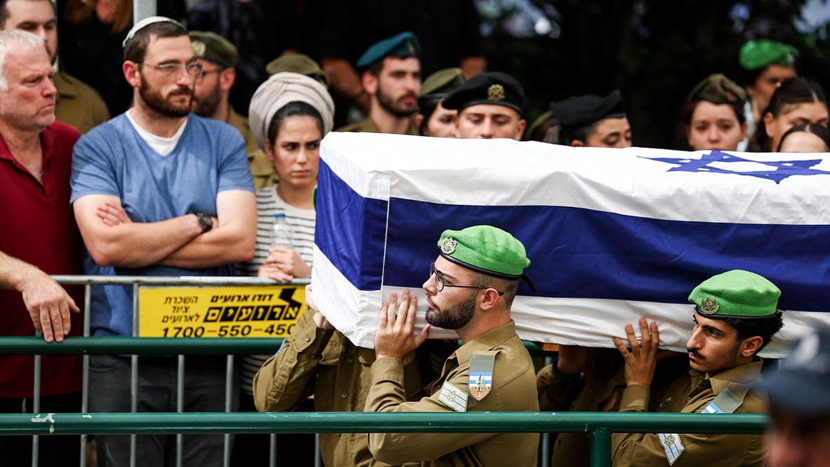 Coffin of Israeli hostage draped in flag
