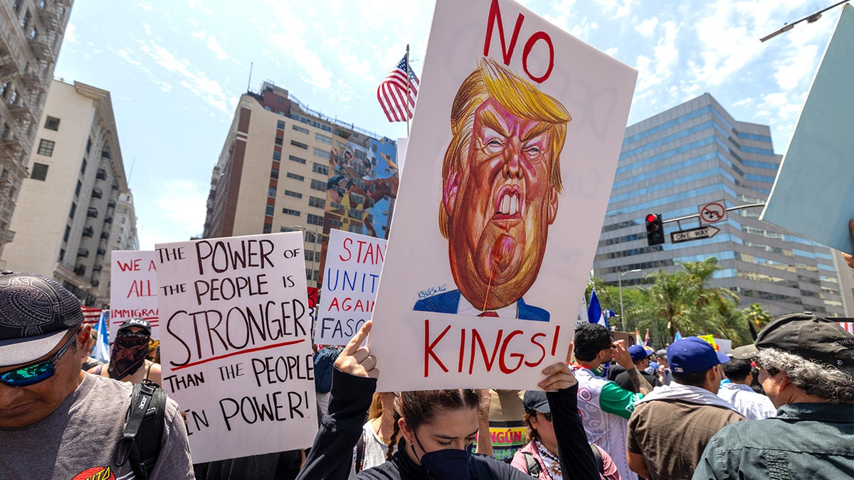 Protesters hold signs and march through city streets during a