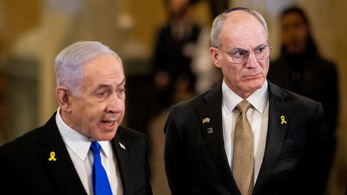 Netanyahu stands next to Ambassador Yechiel Leiter