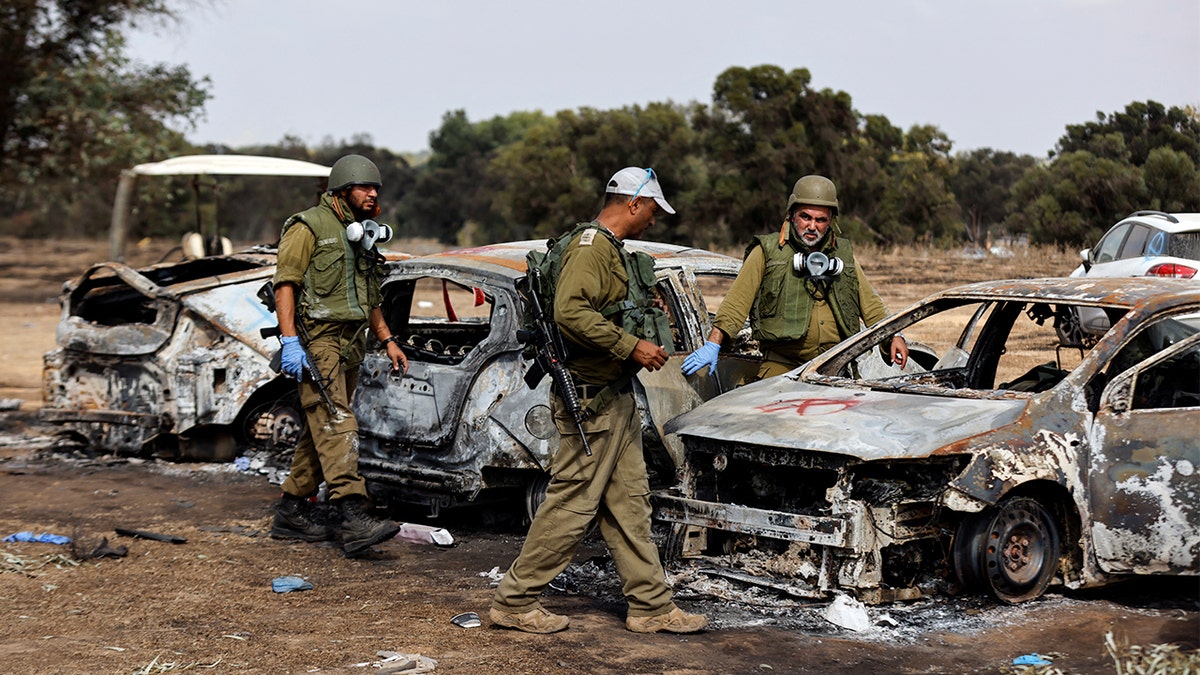 IDF soldiers inspect aftermath of Hamas attack on the Nova music festival.