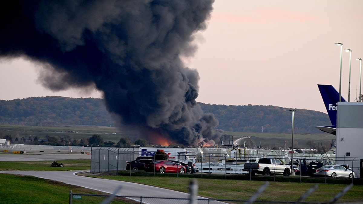 Black smoke billows from the Louisville plane crash.