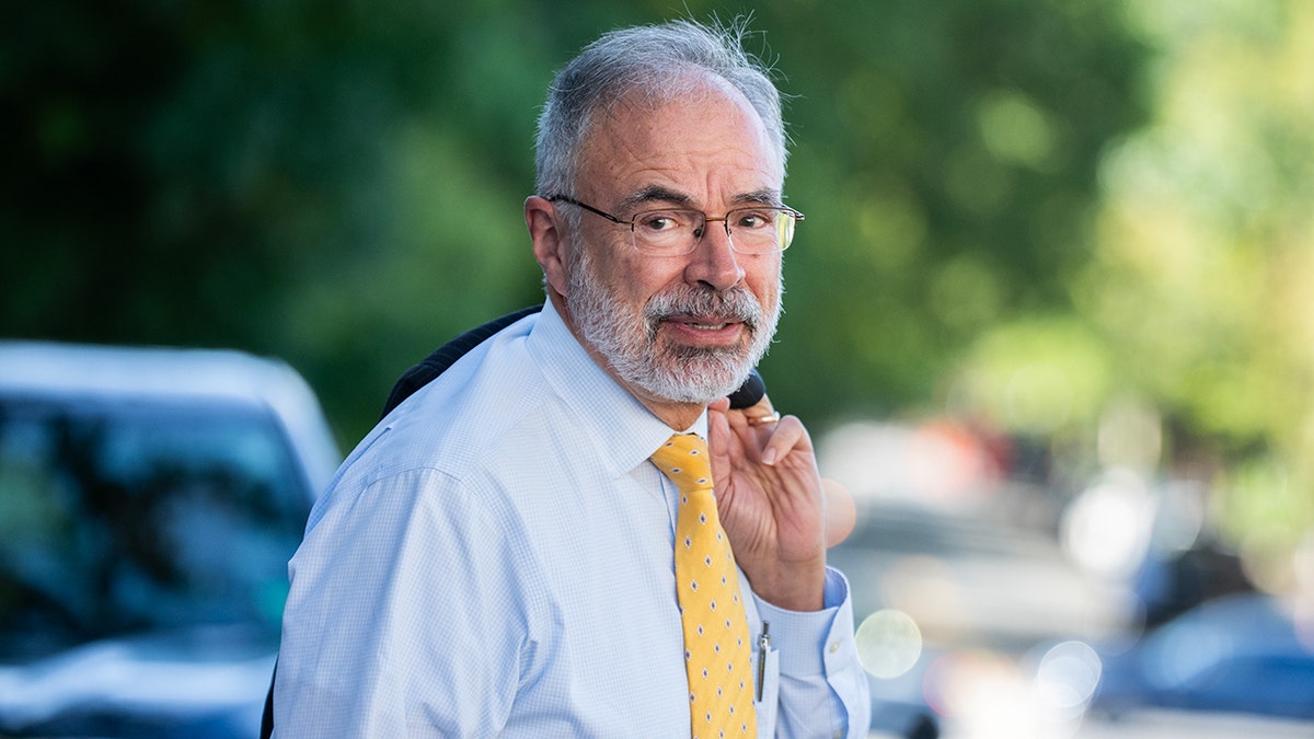 Rep. Andy Harris walking with jacket over shoulder