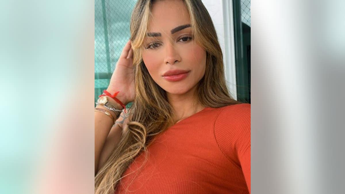 Diana Areas taking a selfie in a red outfit