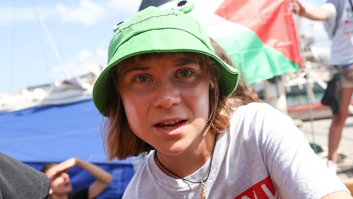 Greta Thunberg wearing a green hat on the flotilla