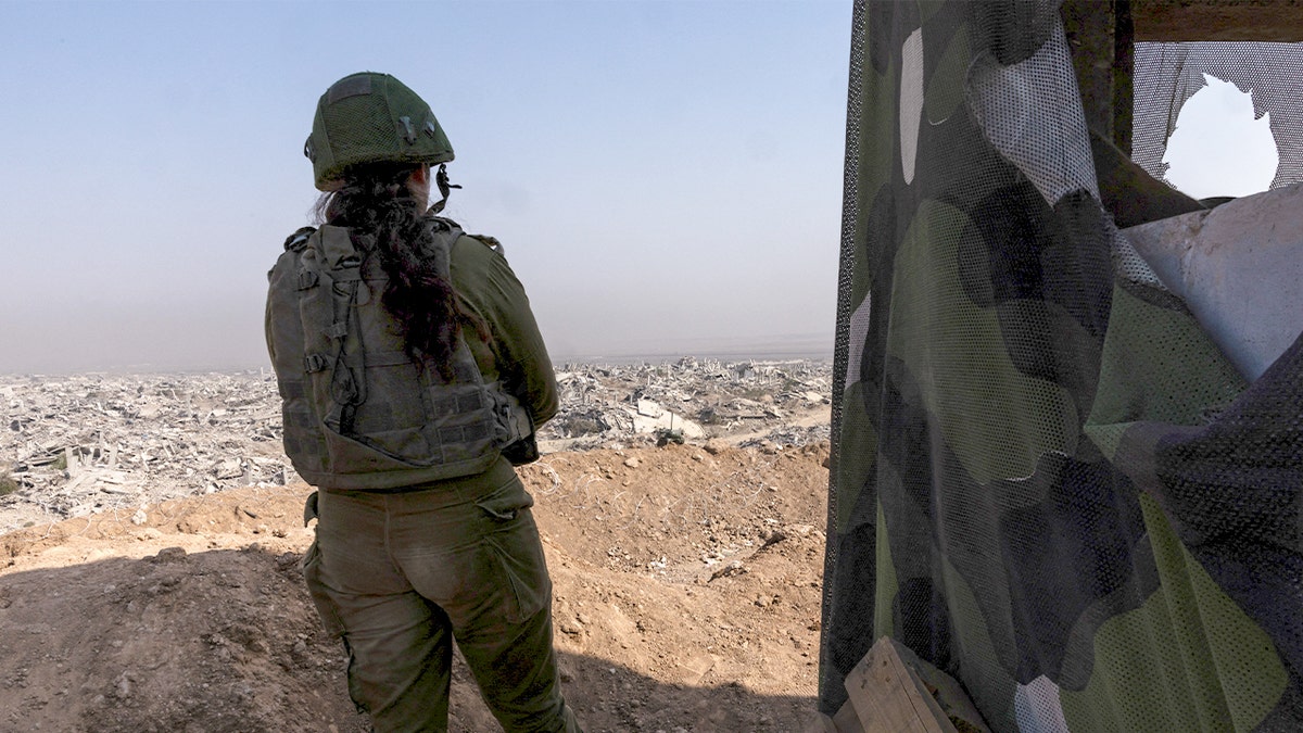 Israeli soldier looks into Gaza