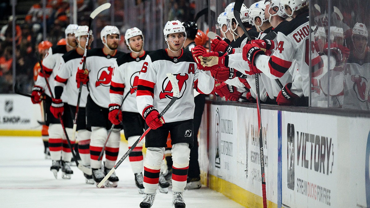 Jack Hughes celebrates with teammates