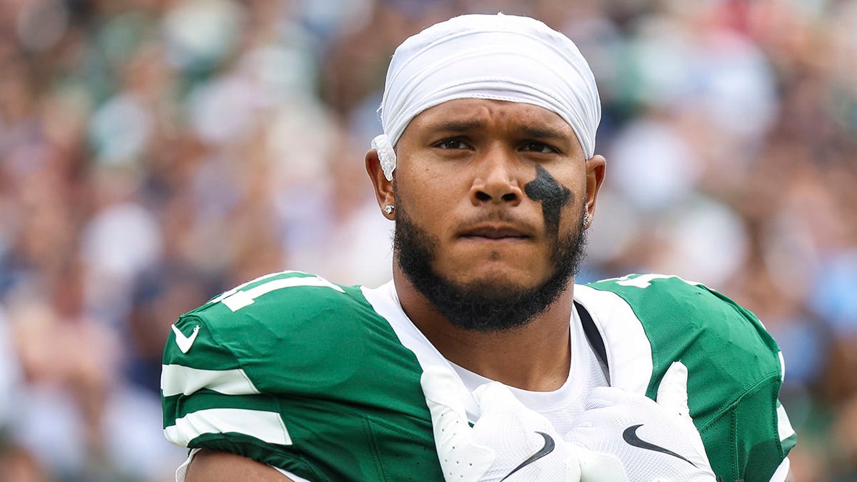 Jermaine Johnson looks on field