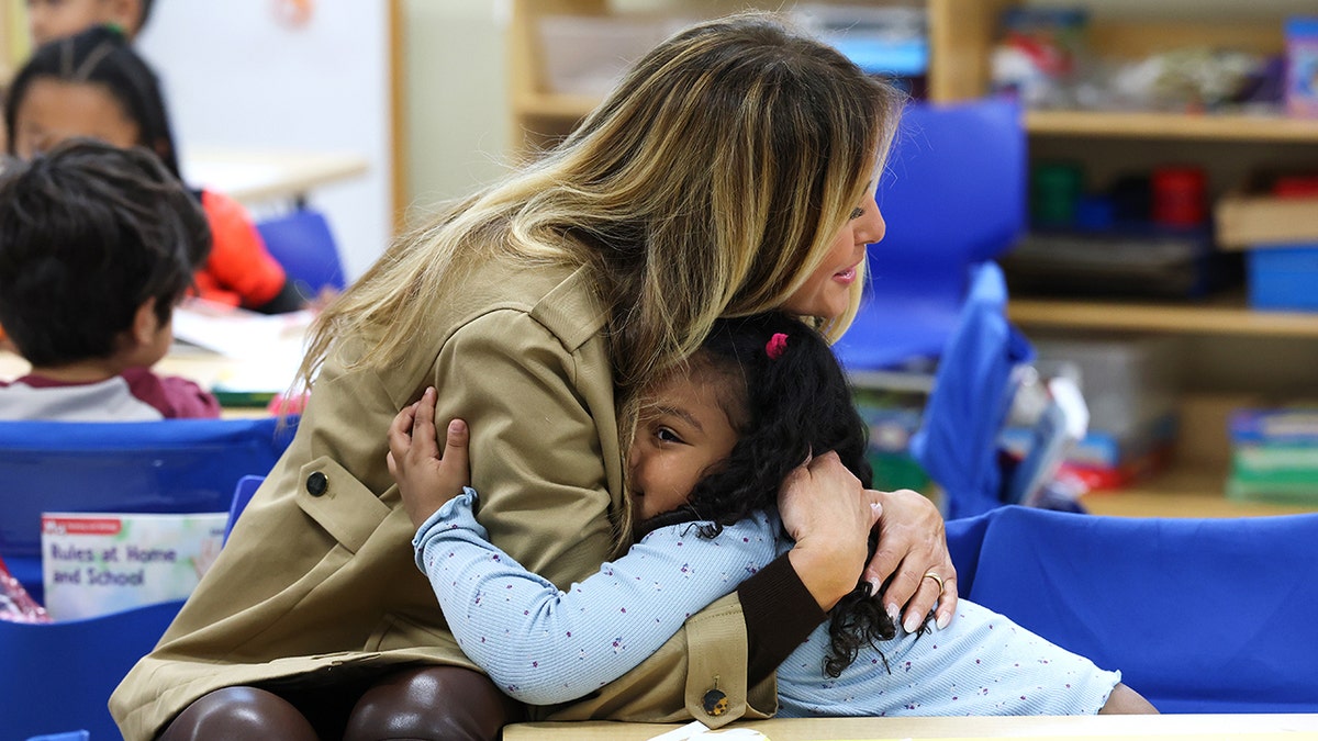 First Lady Melania Trump hugs student