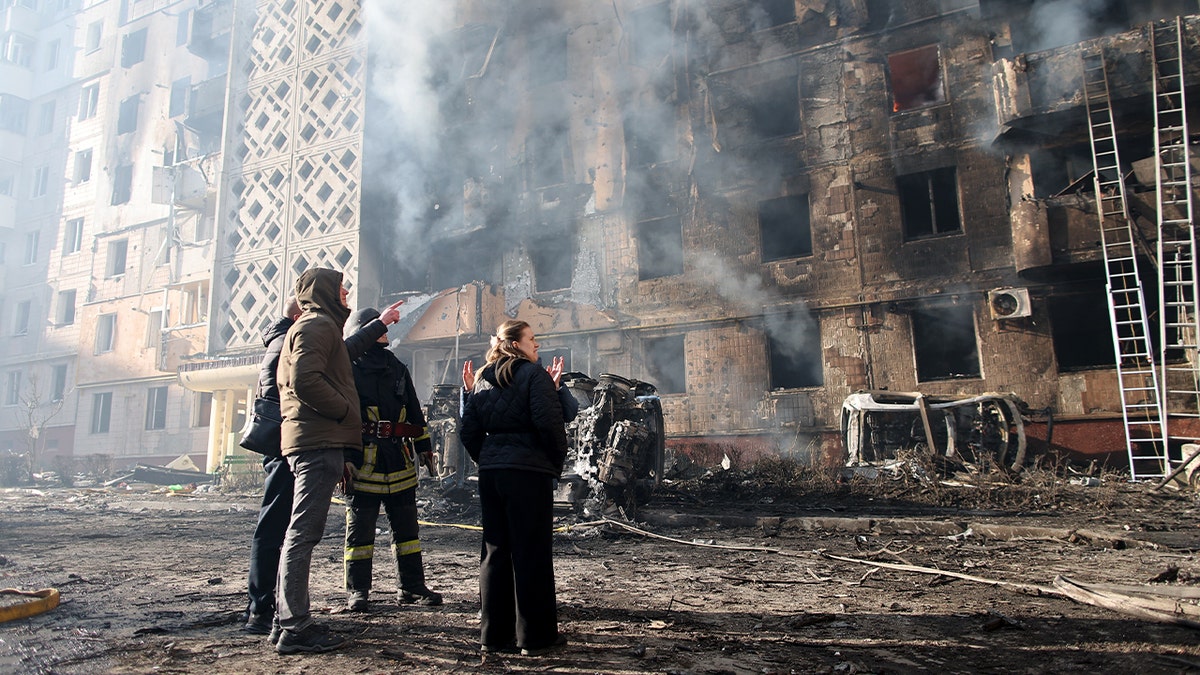 Residents observe the ruins of an apartment building severely damaged by an airstrike in western Ukraine.