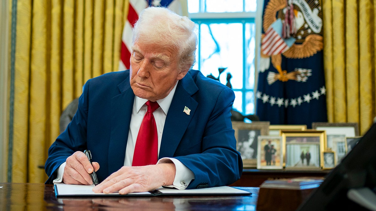 President Donald Trump signs an executive order.