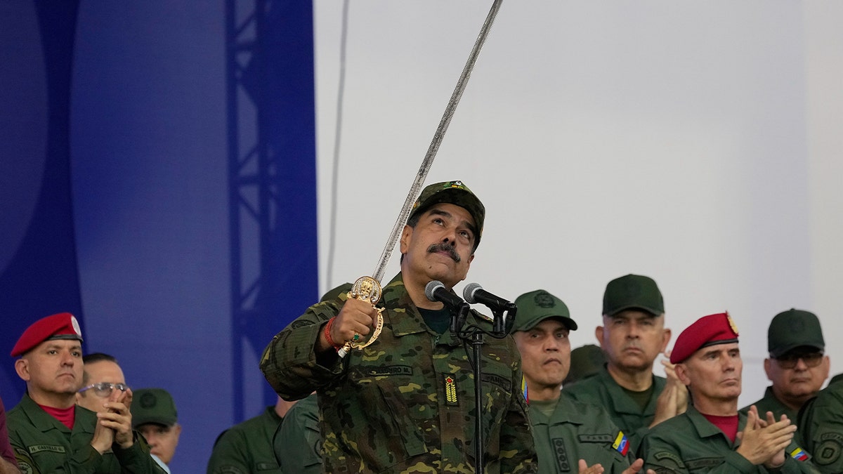 Nicolás Maduro waves a sword during speech
