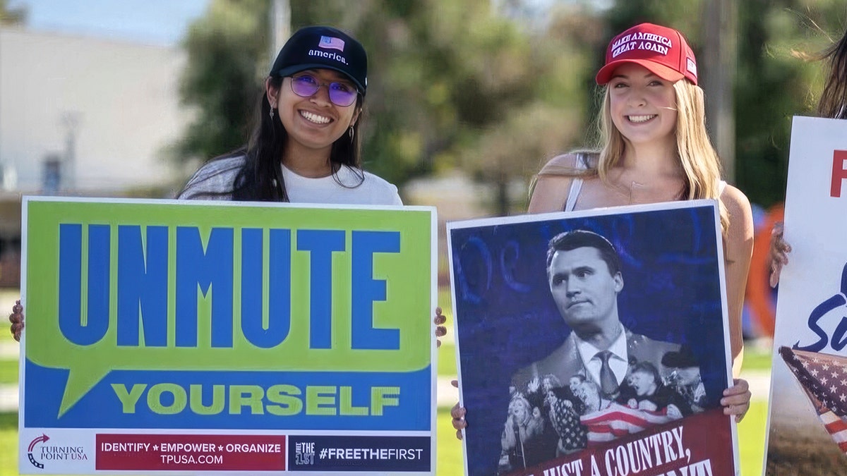 Sadie Burnett in a MAGA hat holding a Charlie Kirk sign