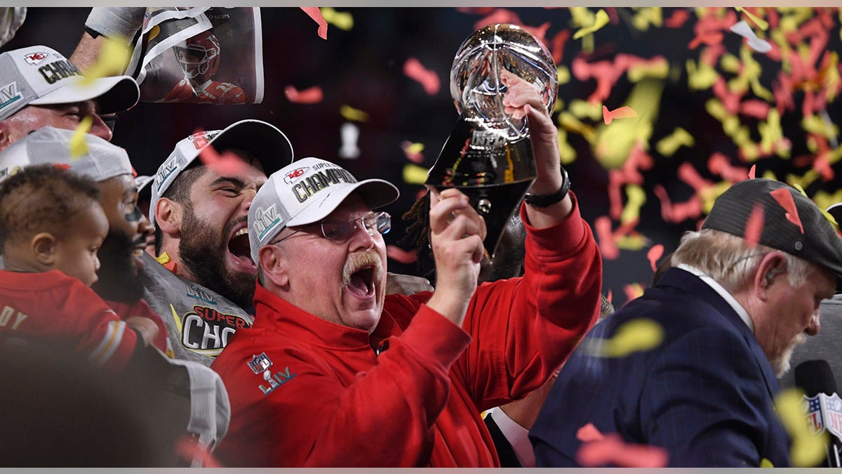 Andy Reid holds trophy