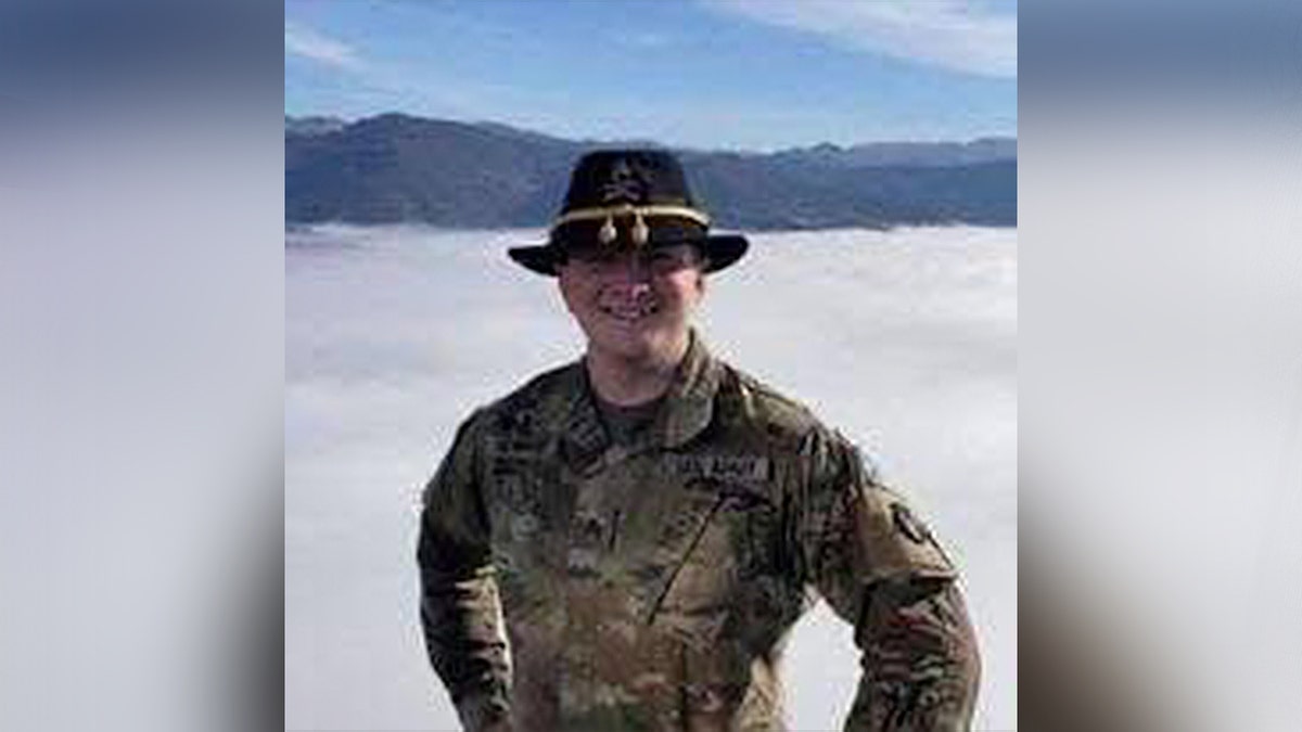 man in military uniform smiling for photo