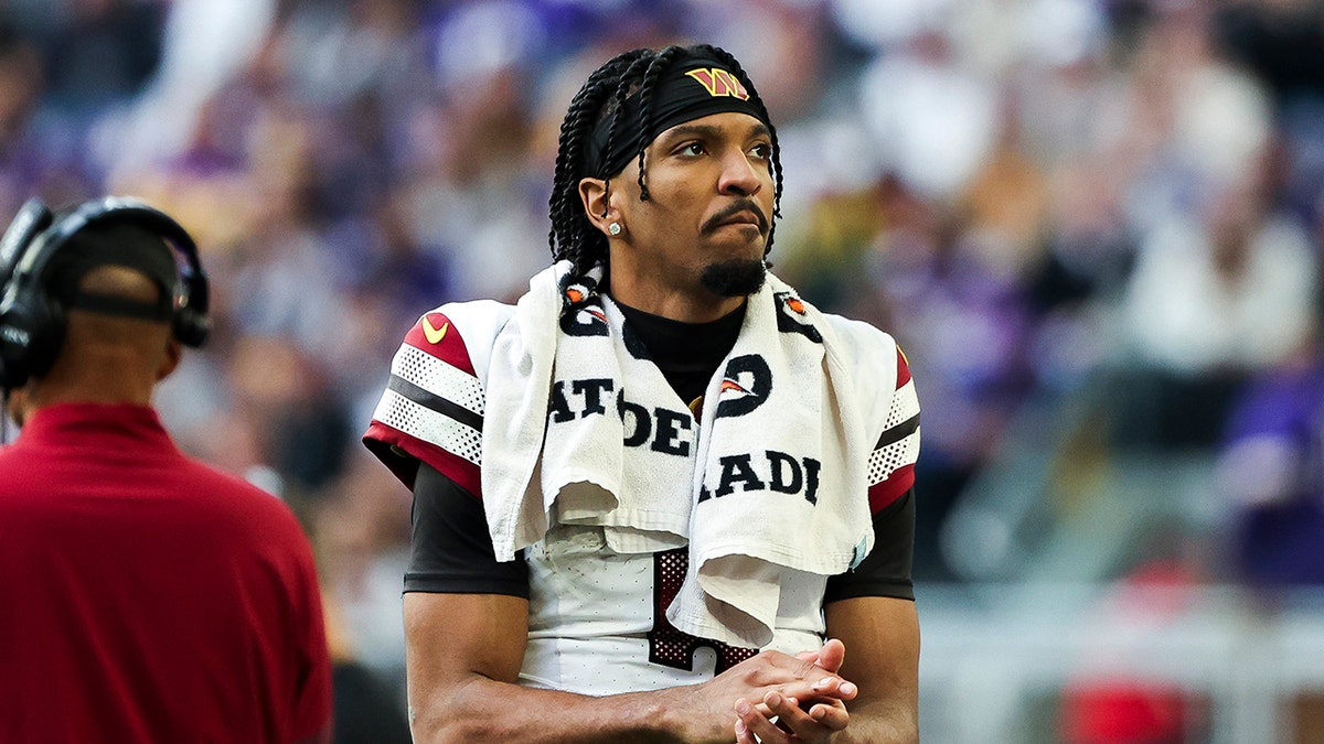 Jayden Daniels looks on field