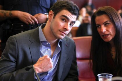 Luigi Mangione pumps fist in court as body cam allegedly reveals loaded magazine found inside wet underwear