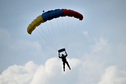 Skydiver survives after reserve parachute accidentally deploys, leaving him dangling from flying airplane