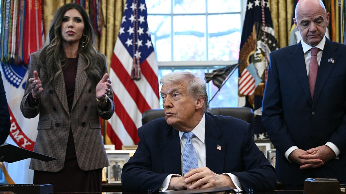 President Trump listens as Secretary Noem speaks