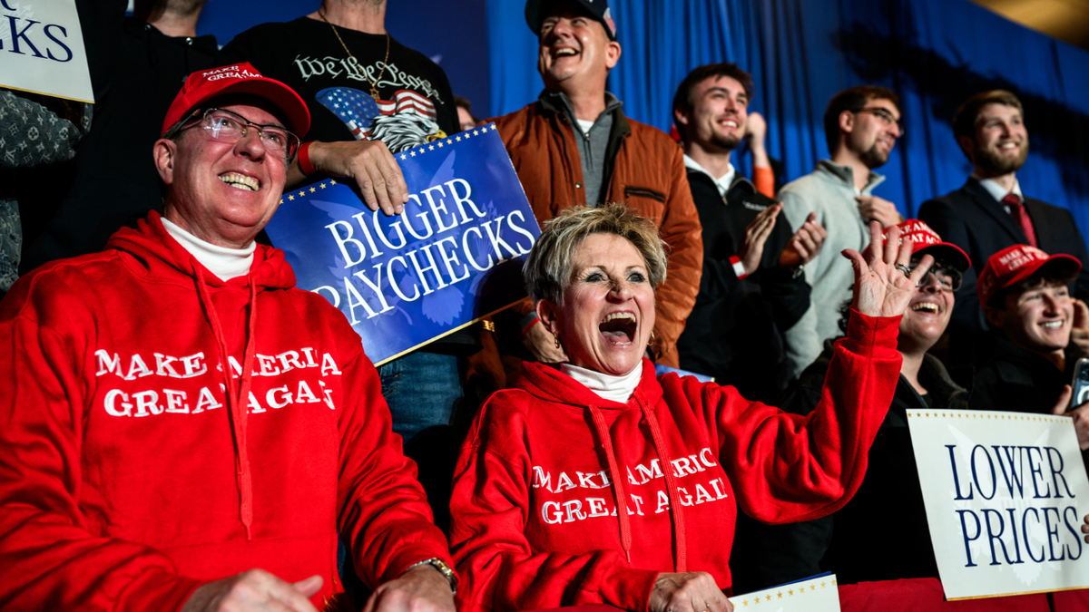 Crowds smile and wave during President Donald Trump's speech on the economy