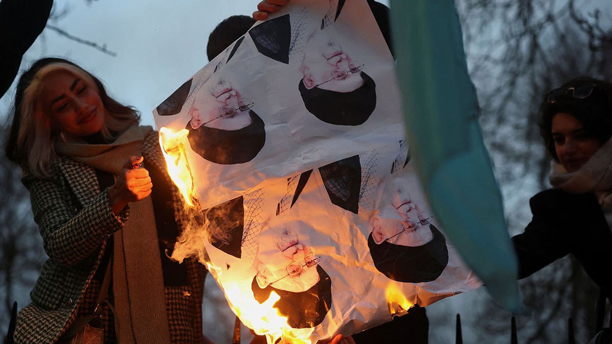 Demonstrators burn pictures of Iran's Supreme Leader