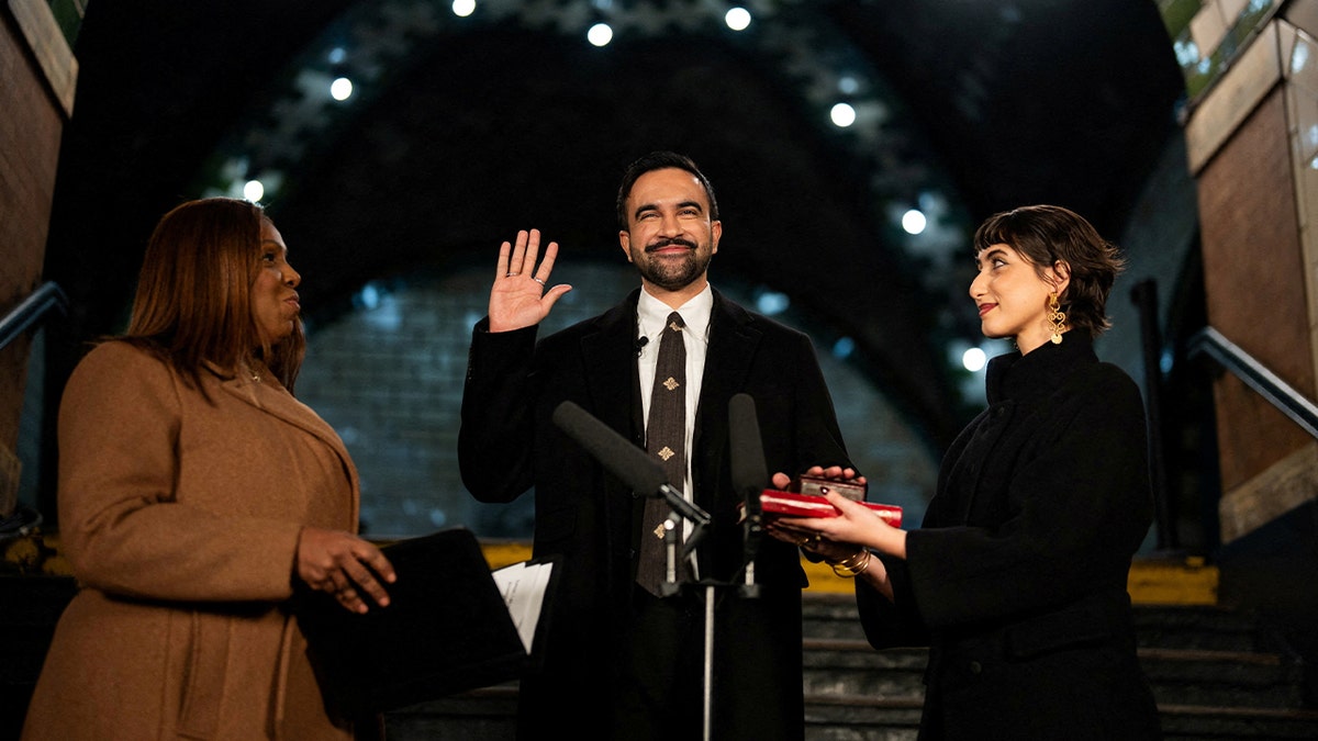 Zohran Mamdani is sworn in as mayor of New York City, flanked by his wife Rama Duwaji and New York Attorney General Letitia James, at Old City Hall Station, New York, U.S., Thursday, Jan 1st 2026.