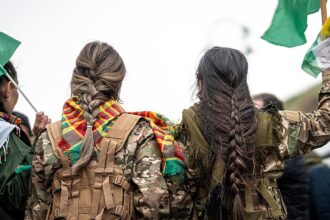 Syrian militiaman shows off what he claims to be severed Kurdish fighter’s braid as Damascus asserts control