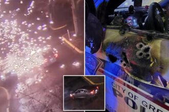 Video shows police officer ambushed in patrol car in explosion of gunfire; suspect found dead after shootout