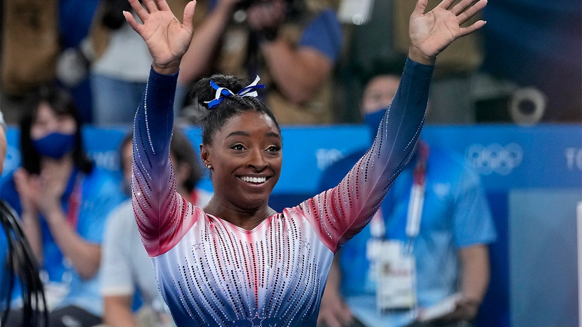 Team USA gymnast Simone Biles waves after performing on the balance beam at the 2020 Olympic Games, in Tokyo.