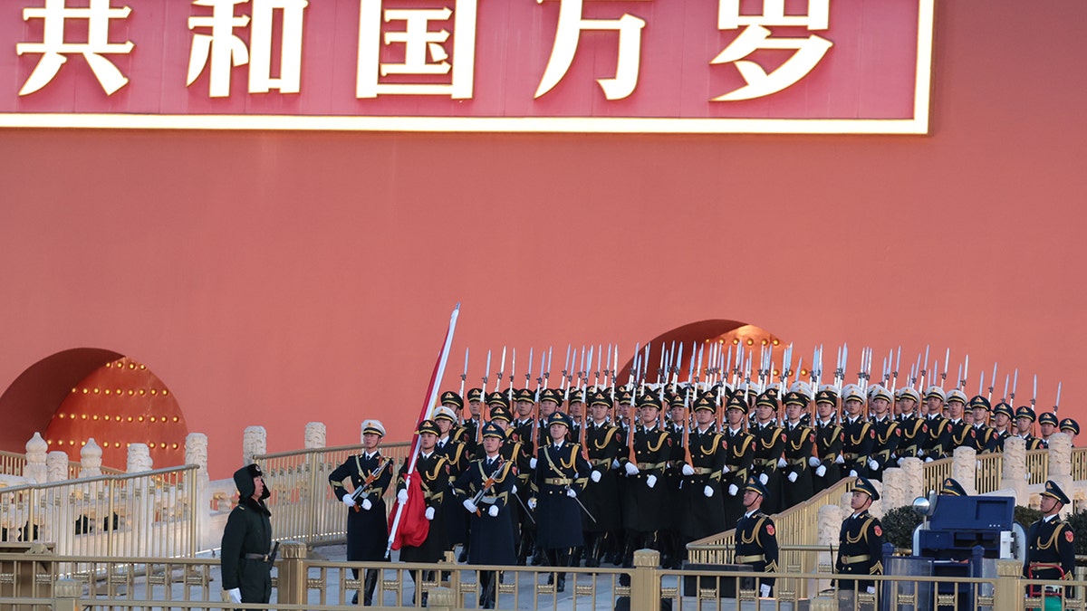 Chinese military members marching through Tiananmen Square