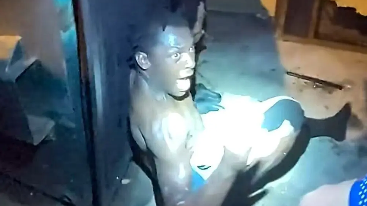 Kewarren Lee Anderson behind a dumpster