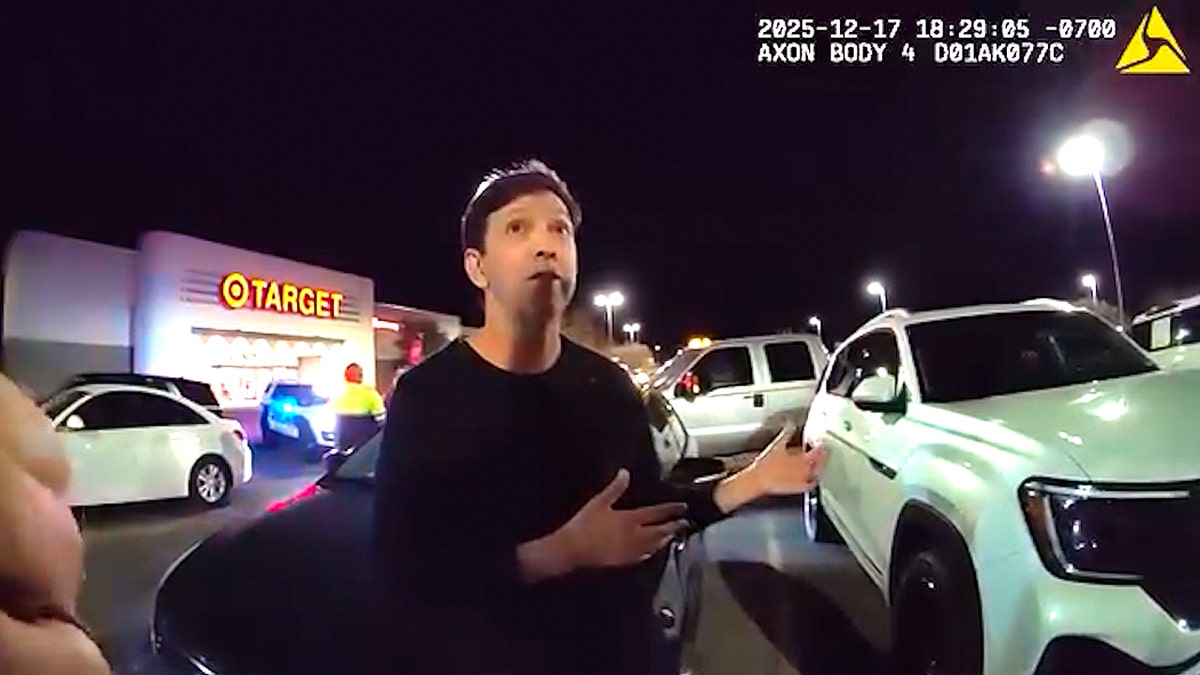 Paul Correa talking to police outside a Target