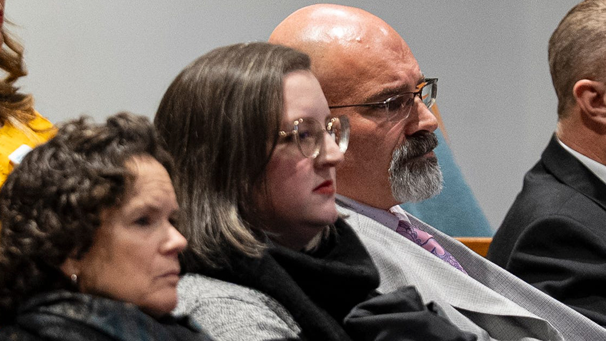 Kyle Hedquist seated during council meeting