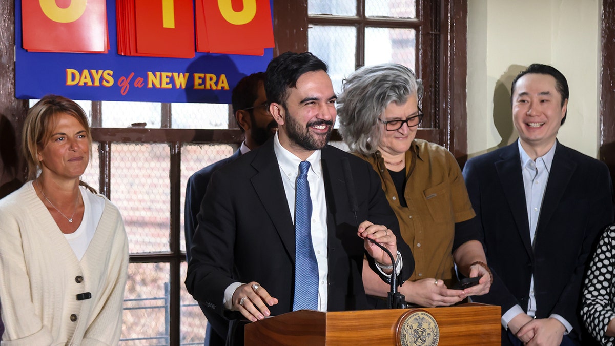 Mamdani smiling during landlord settlement presser