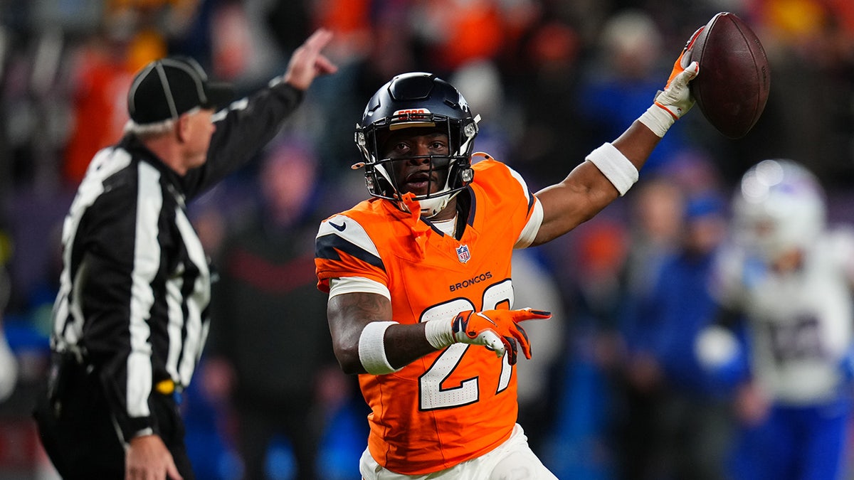 Ja'Quan McMillain raises the football