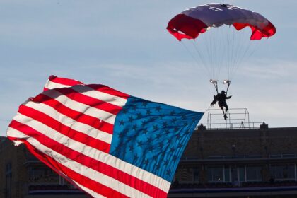 Parachutist briefly hangs above end zone during Armed Forces Bowl pregame mishap