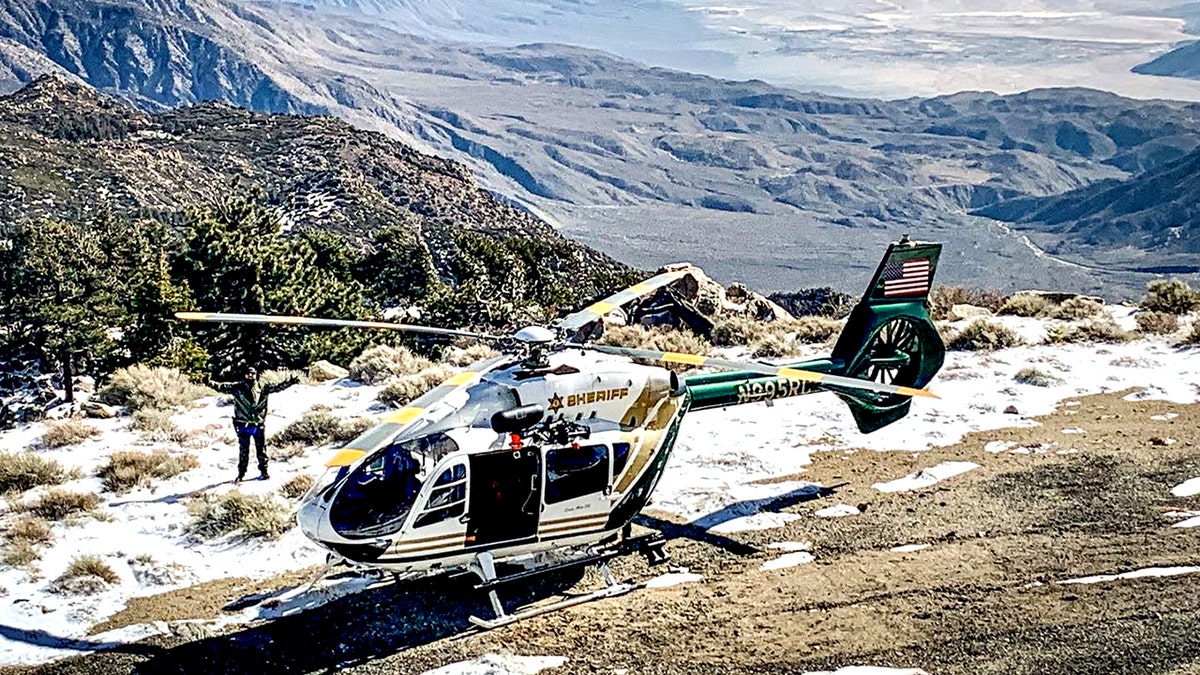 Riverside County Sheriff's Aviation Unit helicopter on mountain with melted snow
