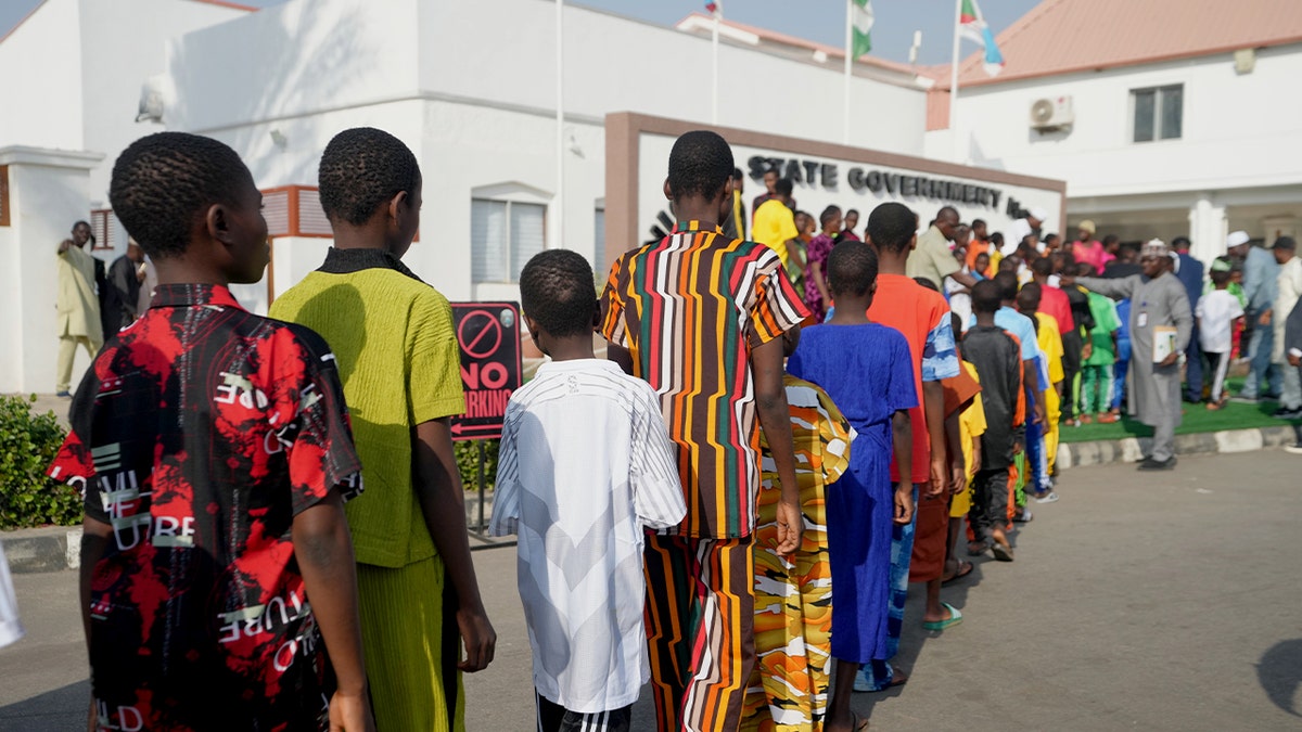 Group of children walk together after being released from captivity.