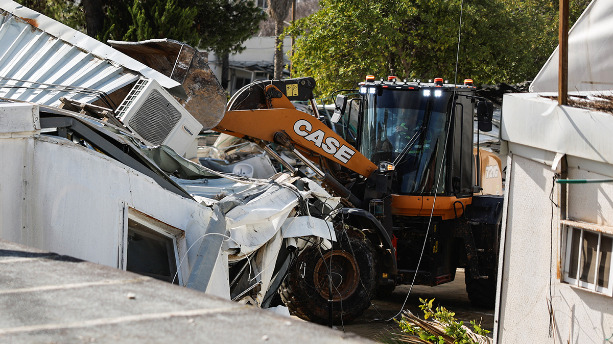 Heavy machinery operates as Israeli forces dismantle the Jerusalem headquarters of the United Nations Relief and Works Agency for Palestine Refugees