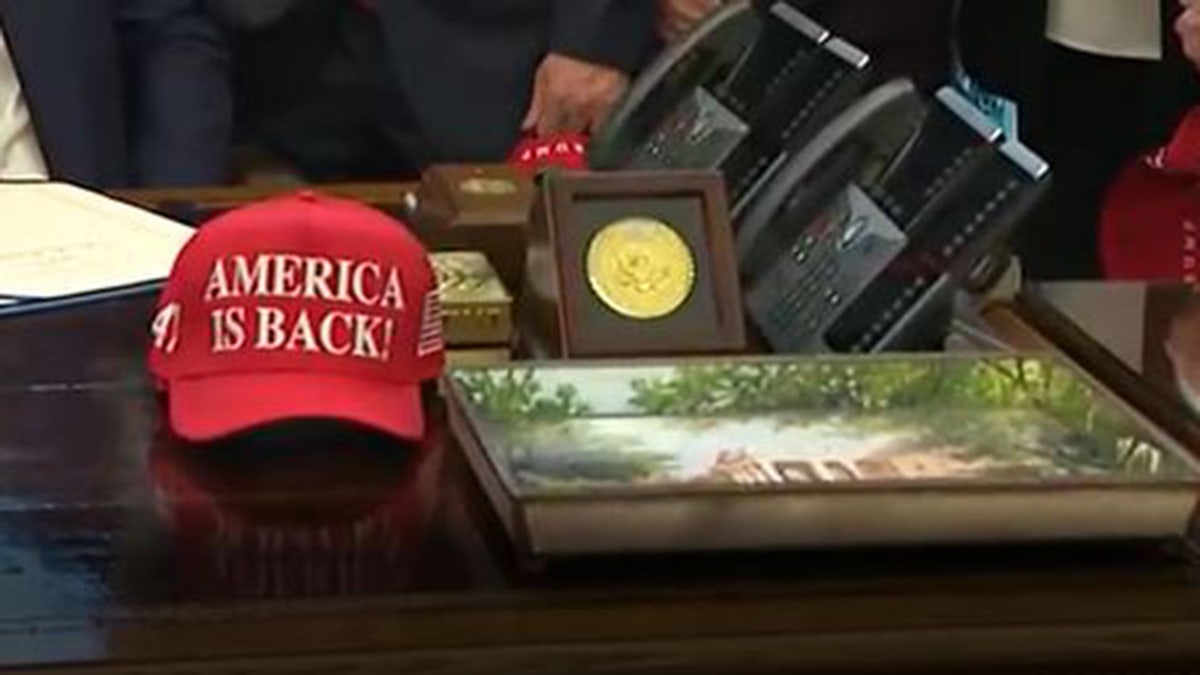 An "America is Back!" hat is seen on the resolute desk, Tuesday, Feb. 3, 2026, after President Donald Trump signed legislation ending the partial government shutdown that began late last week.