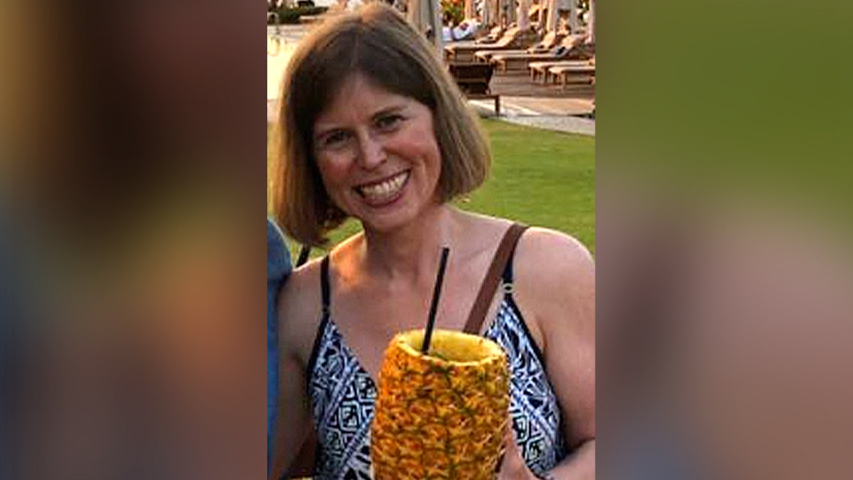 woman holding pineapple drink during vacation