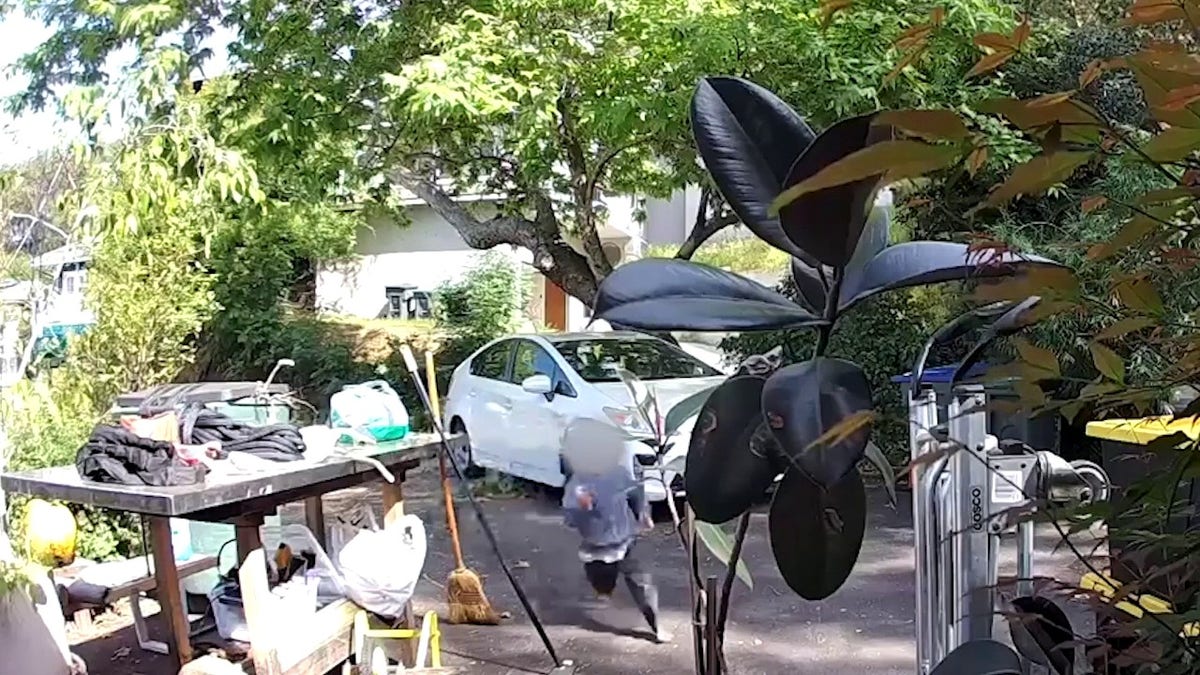 child running in driveway of home