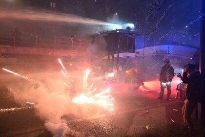 Fireworks fly as hooded protesters clash with police after Olympics open in Milan