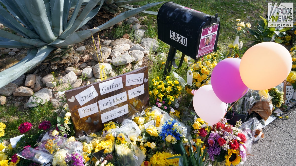 A pile of flowers near the mail box of Nancy Guthrie.