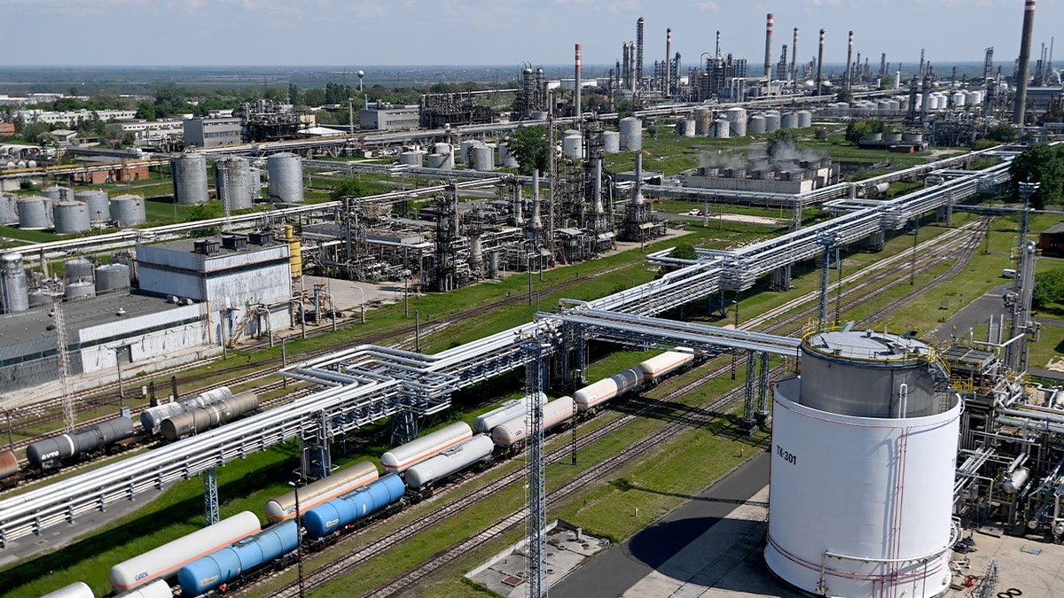 Industrial refinery complex with storage tanks and processing towers near Szazhalombatta, south of Budapest.