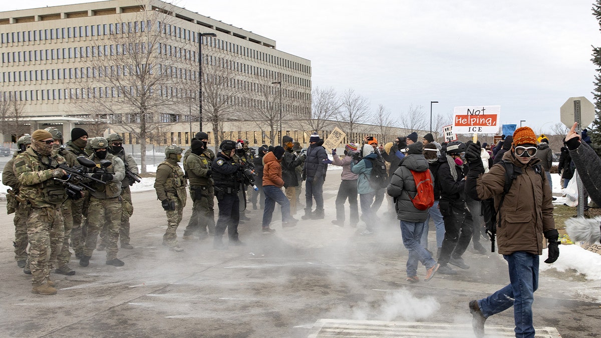Federal officers fire pepper balls toward a group of demonstrators during a protest in Minneapolis.