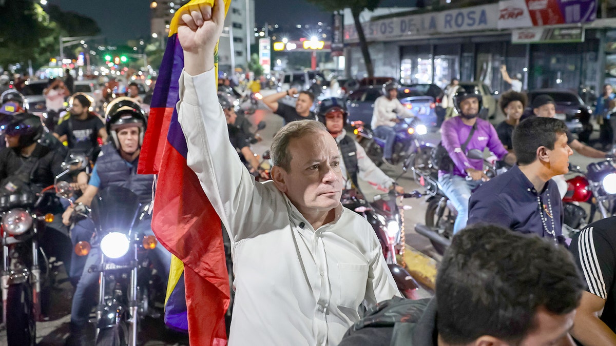 A recently freed opposition figure speaks with families gathered outside a high-security detention facility in Caracas.