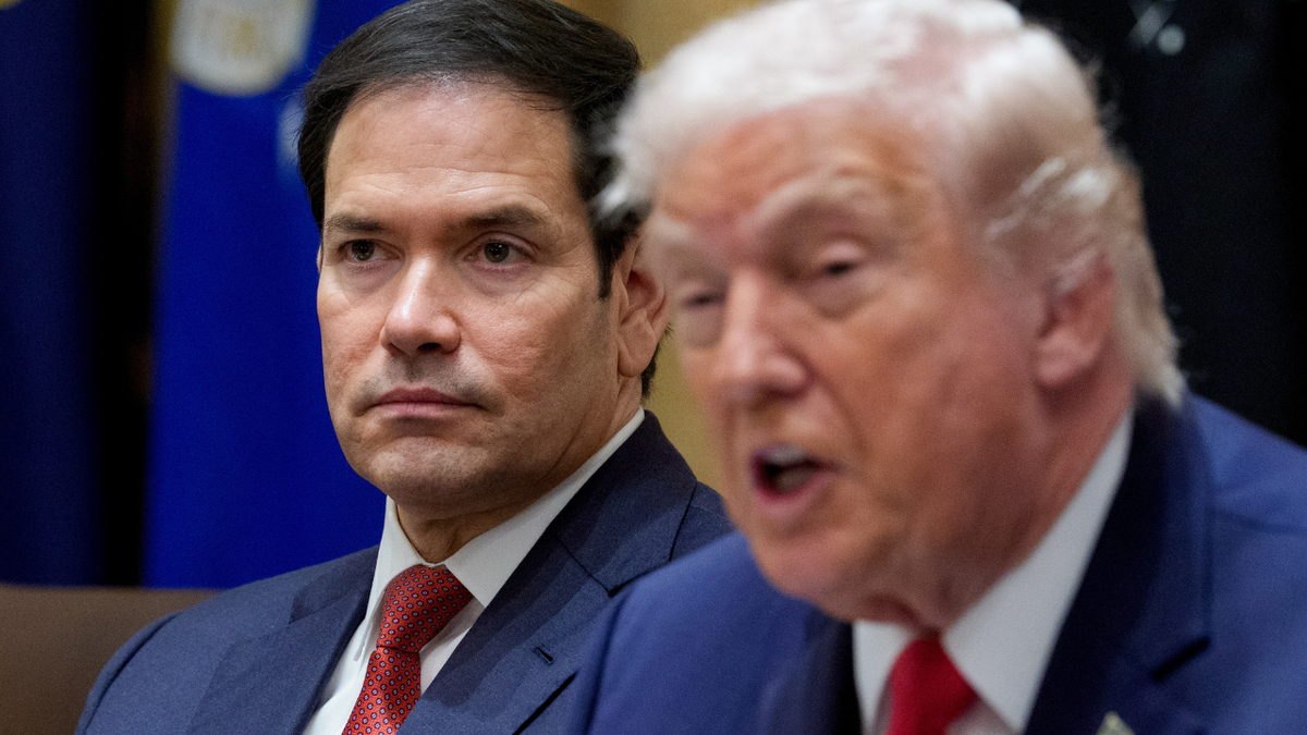 U.S. Secretary of State Marco Rubio is seen sitting next to President Donald Trump listening during a Cabinet meeting.