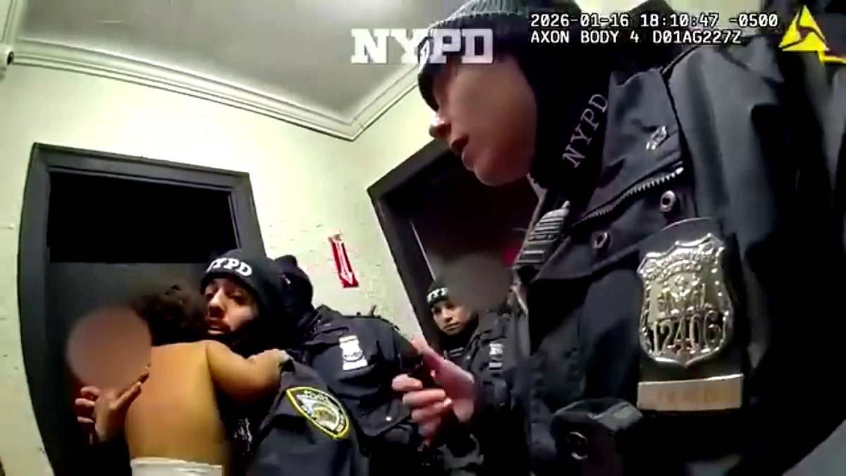 A police officer holding a child.