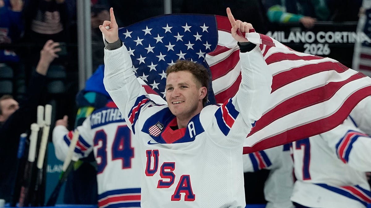 Matthew Tkachuk holds the American flag