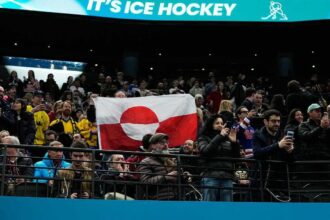 Olympic hockey fans raise Greenland’s flag during USA’s dominant win over Denmark, sparking viral reaction